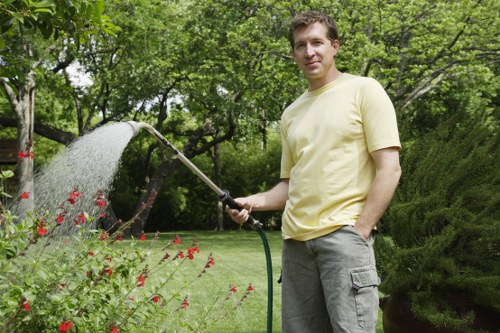 Landscaping team sorting green waste for eco-friendly disposal in Wimbledon